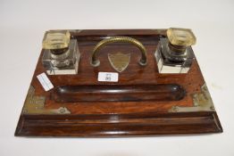 Early 20th century oak desk set with brass mounts to corners and two glass inkwells with pen