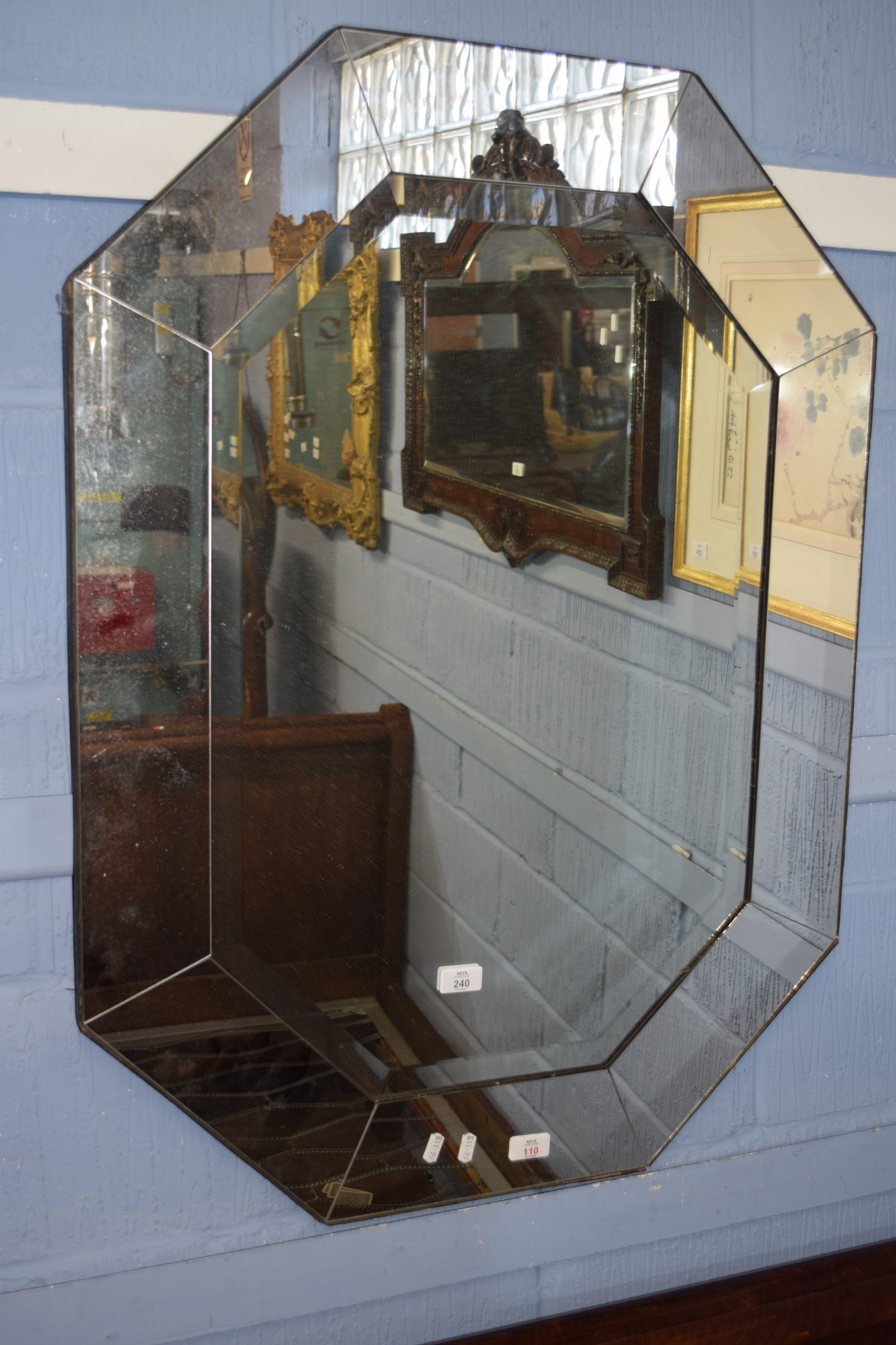 Art Deco style shaped octagonal wall mirror with segmented edge and bevelled glass to centre, 70cm x
