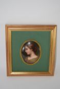 KPM style oval plaque of a young lady in gilt frame on green mount within further modern frame