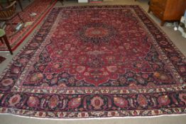 Large red ground Persian Mashad Carpet, mutlicoloured with traditional design 388cm x 270cm approx