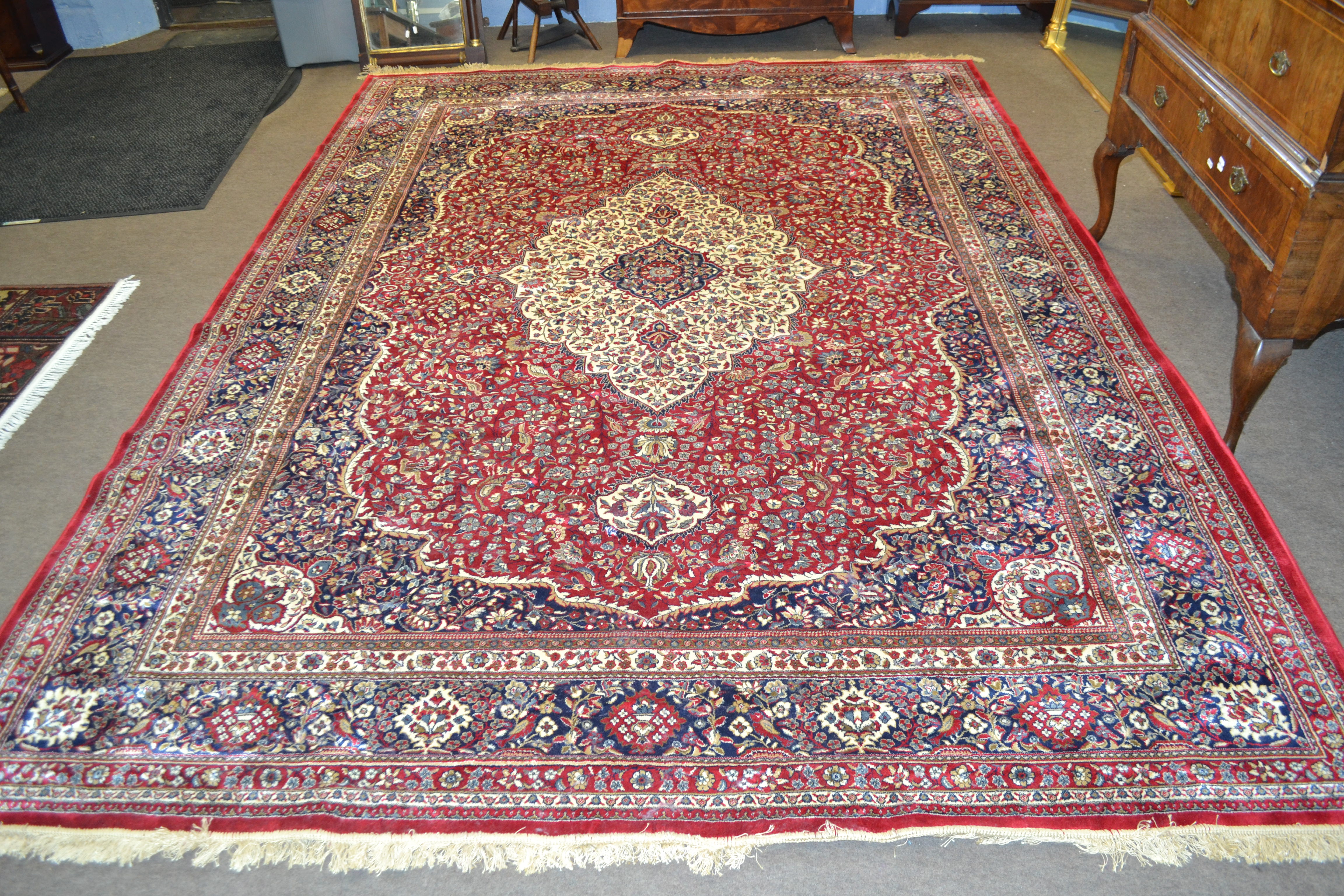 Large red ground full-pile Kashmir Carpet, floral medallion design, 340cm x 230 cm approximately