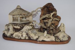 Intricate Japanese diorama depicting a mountainous landscape with pavilions and figures in wood,
