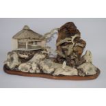 Intricate Japanese diorama depicting a mountainous landscape with pavilions and figures in wood,