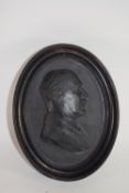 Framed oval cast metal relief of a gentleman, initialled EHW and dated 1925