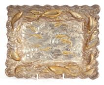 Unusual cast metal dish of rectangular form with gilt decorated fish swimming in a textured wave