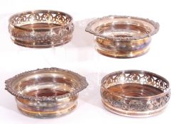Mixed Lot: two pairs of antique silver plated coasters, one with pierced sides and treen centres,