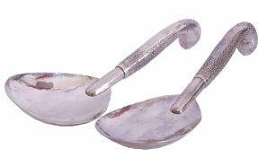 Pair of large Continental white metal serving spoons, with large shaped oval bowls to chased and