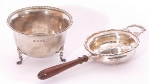 Silver tea strainer and bowl, the strainer with engraved and pierced bowl, applied scroll border and