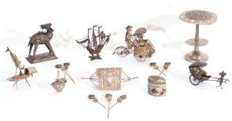 Mixed Lot: a small group of Oriental/Foreign white metal souvenir wares including figure propelled