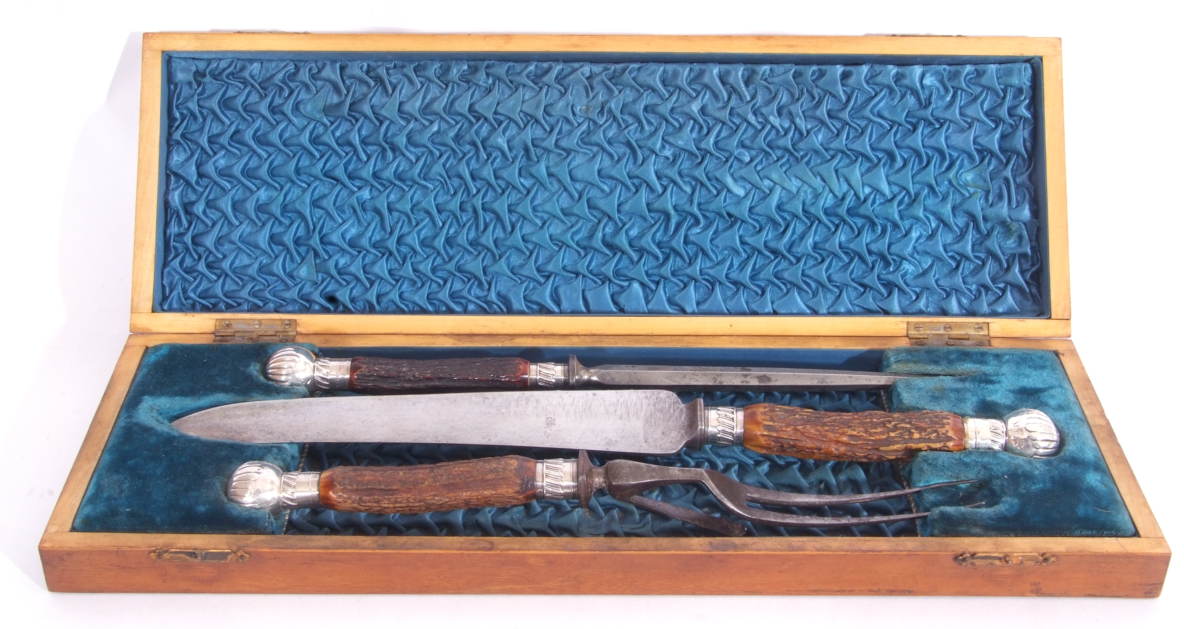 Cast Victorian three piece cased carving set with stag antler handles, silver mounts marked to