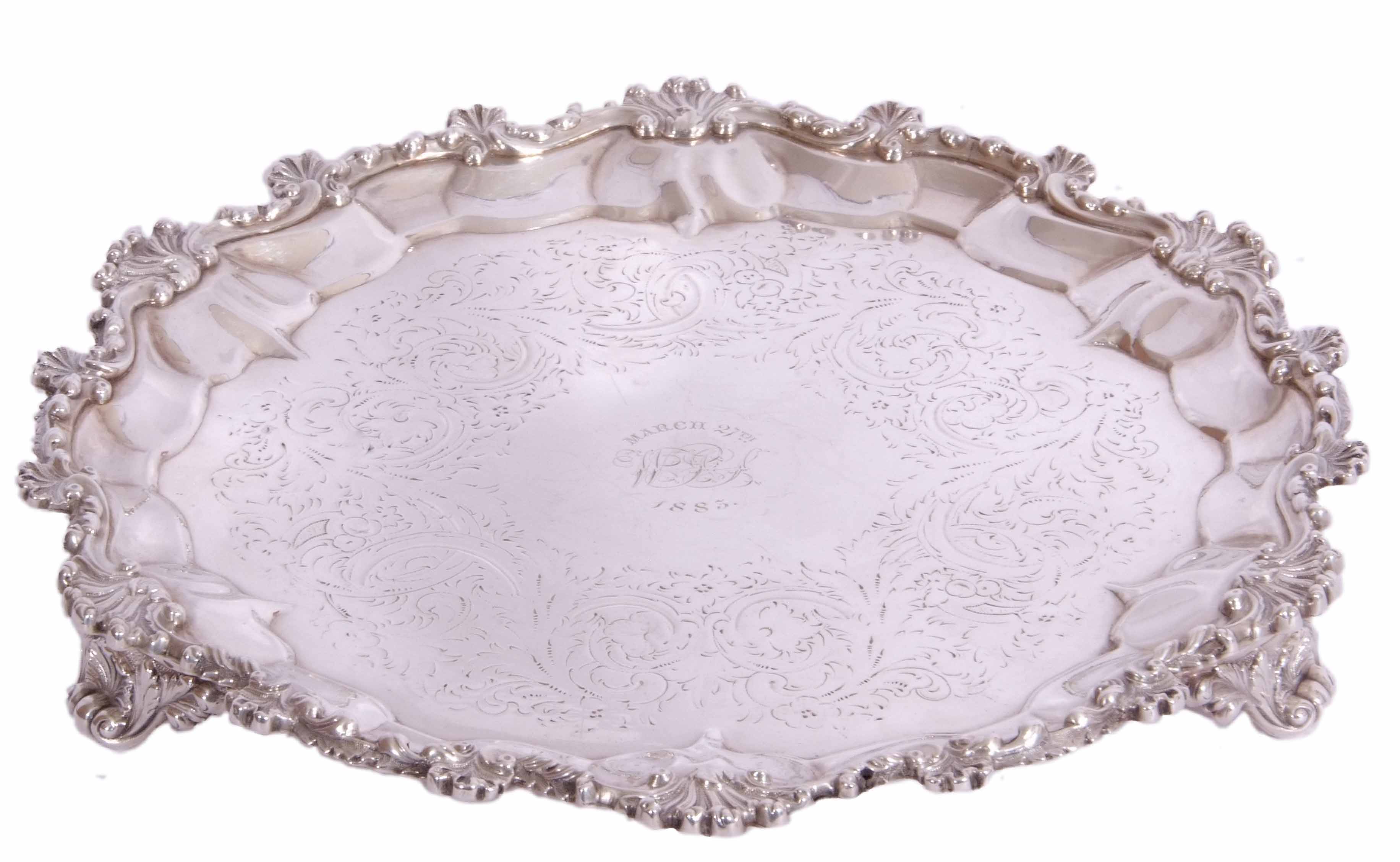Victorian silver salver with crest dated 1883, shaped circular form on three scroll and shell feet