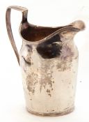 George III milk jug of plain polished helmet form with reeded rim and strapwork handle (repaired),