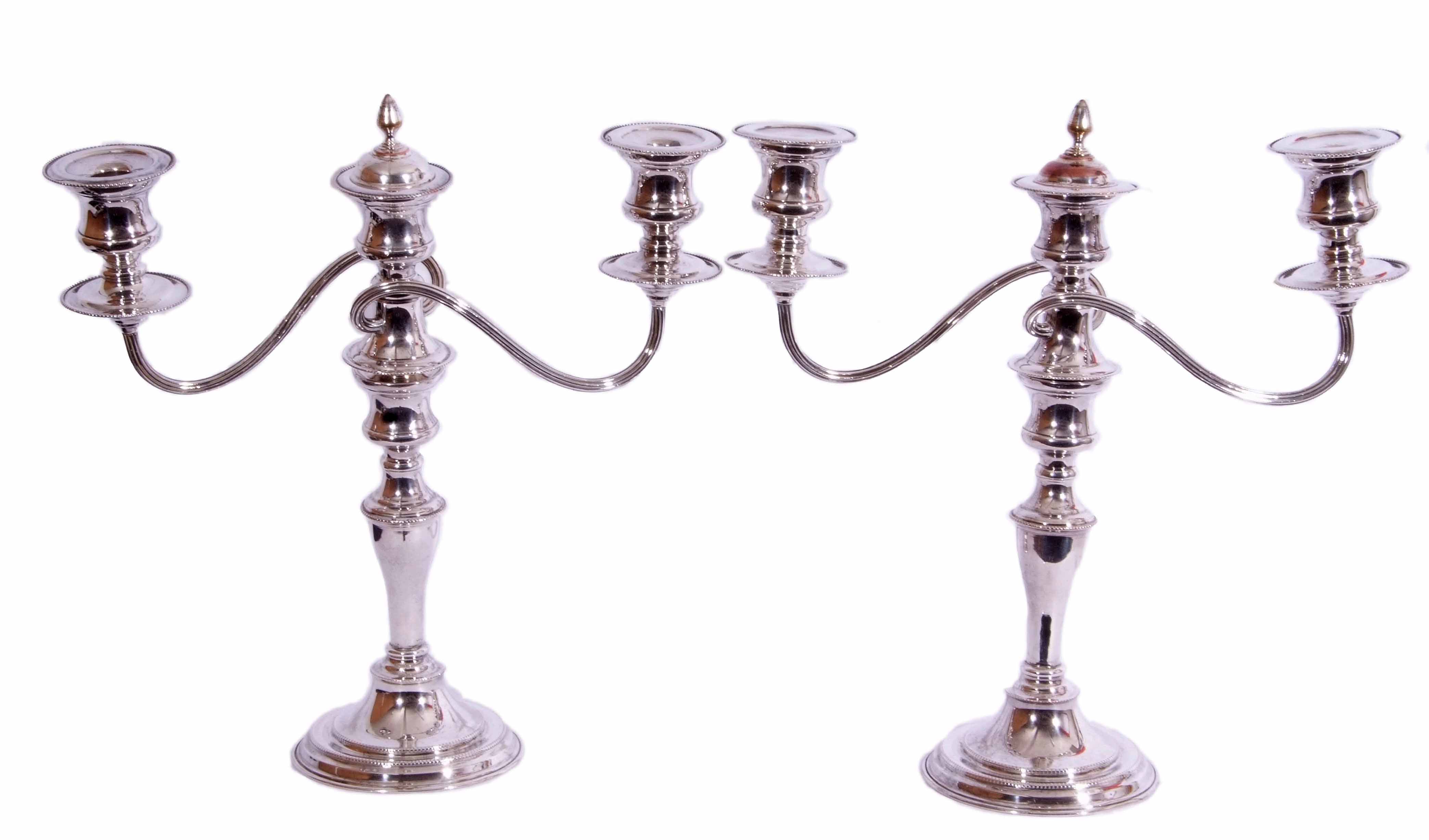 Pair of silver plated twin branch candelabra with detachable sconces and urn finials, beaded