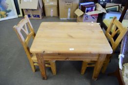 MODERN PINE CHILD'S TABLE WITH TWO CENTRAL DRAWERS, PLUS TWO MATCHING CHAIRS, THE TABLE 76CM WIDE