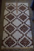 GEOMETRICALLY PATTERNED BEDSIDE RUG, APPROX 130 X 70CM