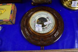 BAROMETER IN CARVED OAK CASE