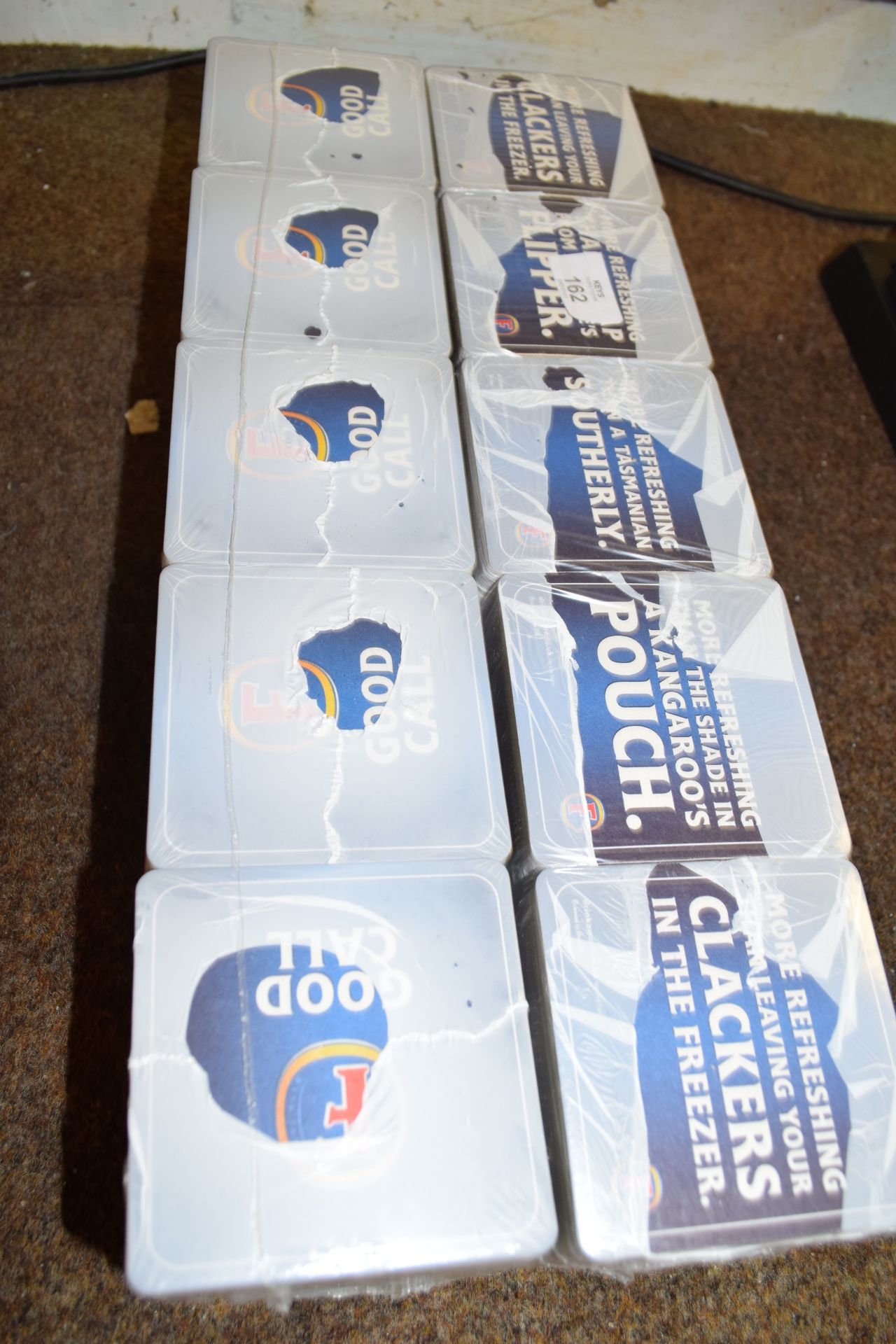 Two packs of Fosters beer mats