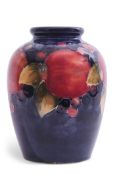 Moorcroft baluster vase decorated with the Pomegranate pattern with green signature to base (chip to