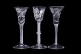 Group of three 18th century wine glasses with air twist and opaque twist stems, one with double