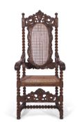 Late 19th century large oak and Bergere armchair in Carolean style, the back featuring carved detail