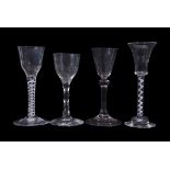 Group of four 18th century wine glasses, two with air twist stems, further glass with faceted