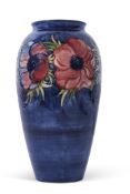 Large Moorcroft vase, the blue ground decorated with a tube lined floral pattern and green leaves,