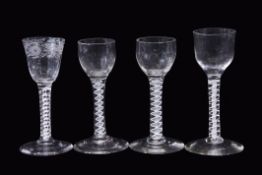 Group of four 18th century drinking glasses, all with air twist stems, one with an engraved bowl