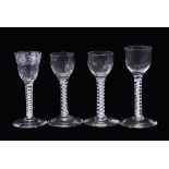 Group of four 18th century drinking glasses, all with air twist stems, one with an engraved bowl