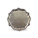Large Victorian salver, circular shaped form on four cast scroll decorated bracket style feet, the