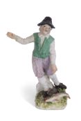 An 18th century Meissen figure of a fisherman or fish seller modelled by Reinicke standing with