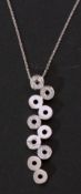 Modern stylised articulated diamond set pendant necklace, a design featuring ten pierced discs, four
