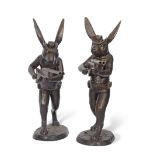 Large contemporary pair of bronze hares wearing hats, rucksacks and cartridge belts and each holding