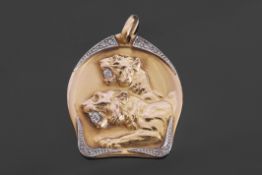 Yellow metal and diamond "lion" pendant, the centre with two lions each with an old cut diamond