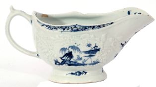 Large Lowestoft sauce boat circa 1765, the body crisply moulded with trailing flowers, bordering a