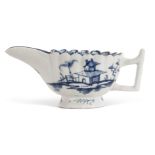 Lowestoft porcelain butter boat with scalloped rim and twig like handle, decorated in underglaze