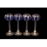 Group of four Bohemian style goblets, the bowls flashed in blue above faceted stems with a design in