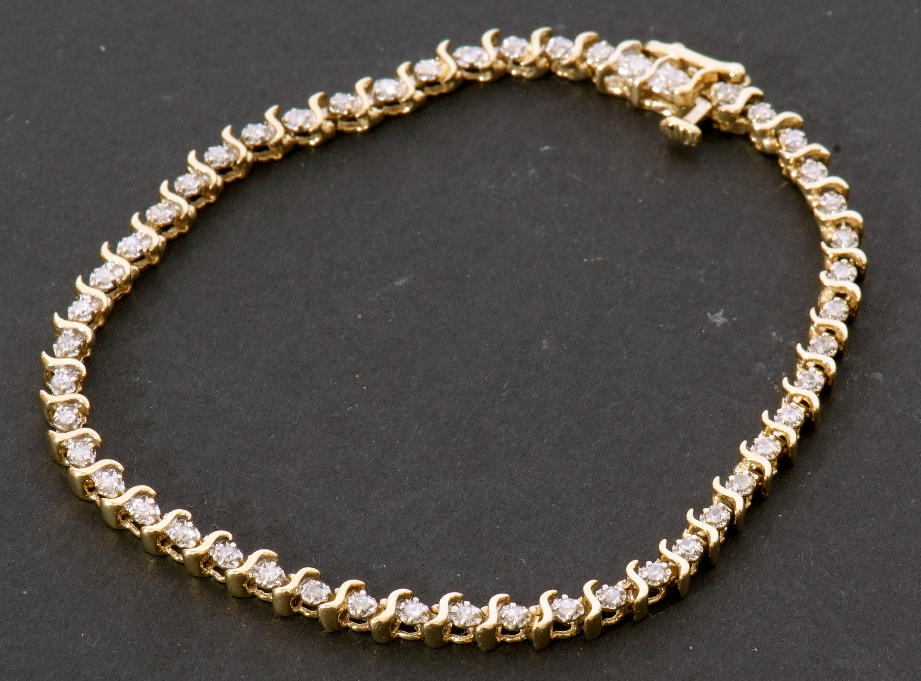 Diamond "tennis" bracelet featuring 49 small diamonds, individually claw set between S-links, - Image 9 of 9