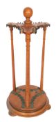 Early 20th century oak revolving cue stand with ring turned central column, ball turned finial, with