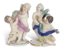 Two mid-18th century meissen groups of putti in typical poses, on shaped bases, 6cm high (2)