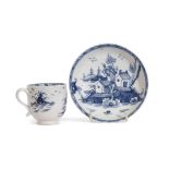 Lowestoft porcelain cup and saucer decorated in underglaze blue with houses and trees, the saucer