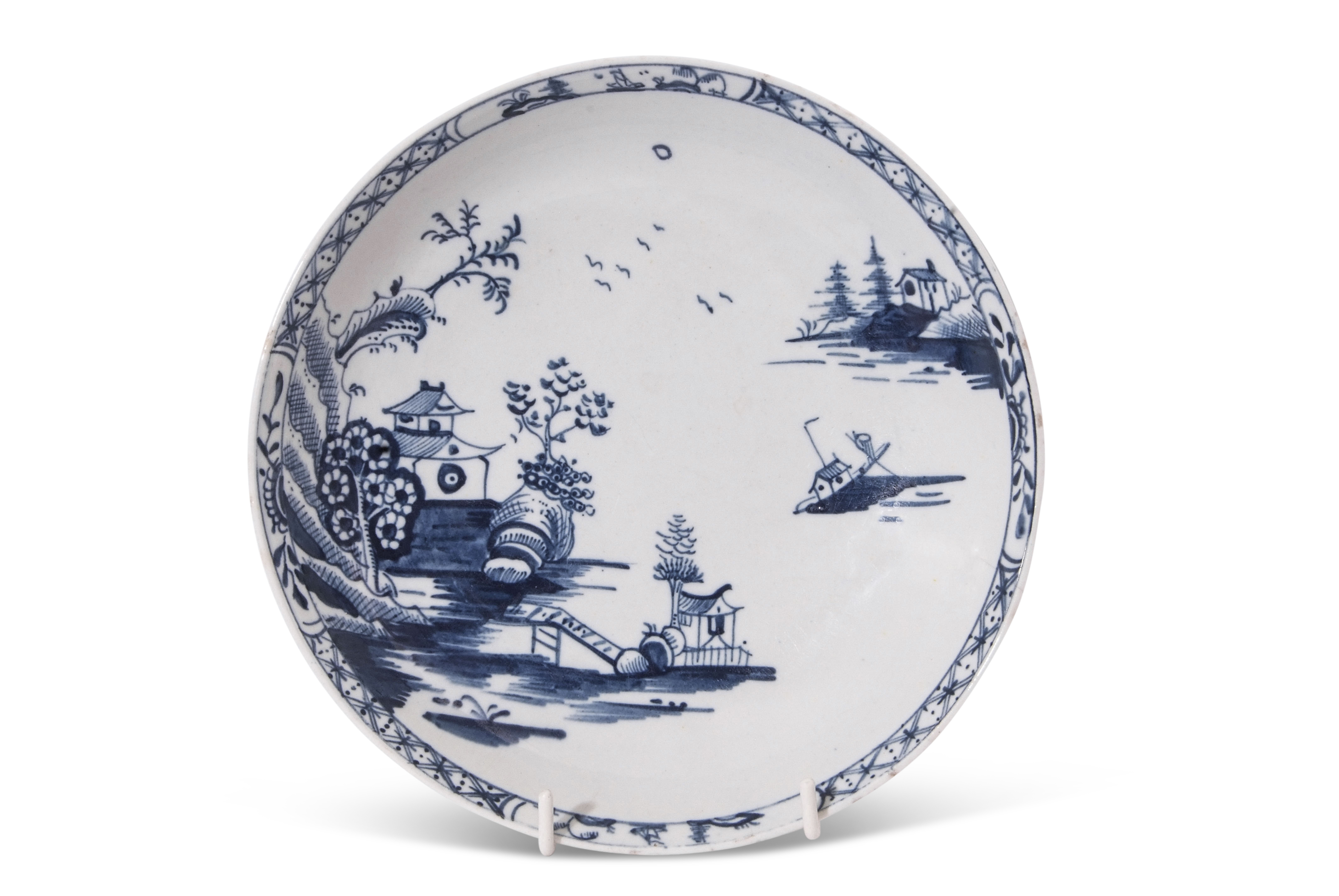 Lowestoft porcelain saucer dish decorated with a chinoiserie river scene, the border with small