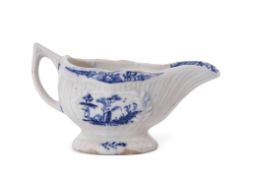 Small Lowestoft porcelain sauce boat or cream boat, the reeded body decorated with vignettes of