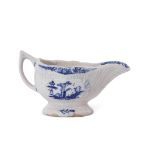 Small Lowestoft porcelain sauce boat or cream boat, the reeded body decorated with vignettes of