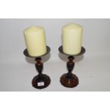 PAIR OF WOODEN CANDLESTICKS AND LARGE CANDLES