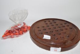 WOODEN BOARD WITH RED MARBLES