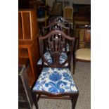SET OF THREE DECORATIVELY CARVED SERPENTINE FRONT SHIELD BACK DINING CHAIRS, EACH WIDTH APPROX 52CM