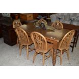 STAINED PINE RECTANGULAR DINING TABLE TOGETHER WITH SIX WHEEL BACK CHAIRS, APPROX 78 X 137CM