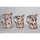 SET OF THREE GRADUATED POTTERY JUGS IN IMARI STYLE