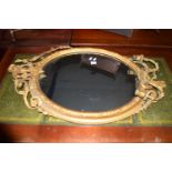 ORNATE GILT FRAMED MIRROR WITH HEAVILY CARVED DECORATION INCORPORATING TWIN CANDLE SCONCES AND