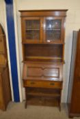 OAK FALL FRONT BUREAU BOOKCASE WITH ASTRAGAL GLAZED CUPBOARD ABOVE IN THE ARTS AND CRAFTS STYLE,